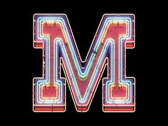 the letter m is made up of neon lights