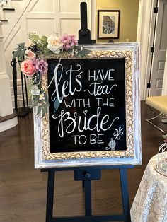 a sign that says lets have tea with the bride to be in front of a table