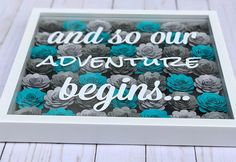 there is a white frame with blue flowers in it and the words, and so our adventure begins