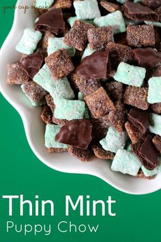 a white bowl filled with chocolate and marshmallows on top of a green table