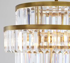 a gold chandelier with clear crystal beads hanging from it's centerpiece