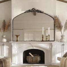 a living room with a fireplace and mirror