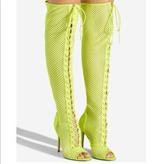 Details A Sexy Over-The-Knee Mesh Boot Featuring A Stiletto Heel, Adjustable Laces, And Back Zipper Closure. Material: Textile/Faux-Suede Calf Circumference: Reg: 16.5"; Wide Calf: 17.5" Color: Neon Yellow Outside Heel Height: 4" Closure: Adjustable Laces Shaft Height: 22" Knee-high Boots For Club In Spring, Trendy Summer Club Boots, Thigh High Heels For Club, Fitted Thigh High Club Heels, Fitted Open Toe Boots For Night Out, Fitted Open Toe Boots For Club, Fitted Thigh High Party Heels, Spring Club Knee-high Heels, Spring Knee-high Boots For Club