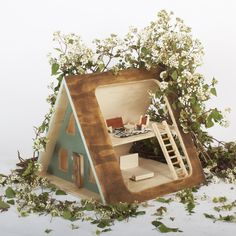 a doll house made out of wood and flowers