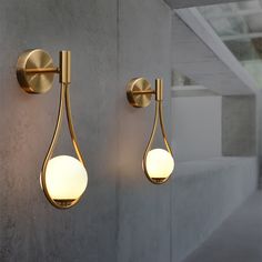 two light fixtures on the side of a wall