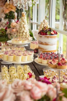 a table filled with cakes and desserts on top of it