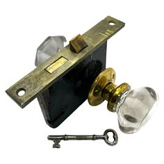 an antique door handle and glass knob with a key