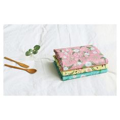 three napkins with flowers and spoons on them