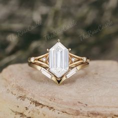 a gold ring with an emerald cut diamond