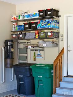 a room with several bins and shelves on the wall