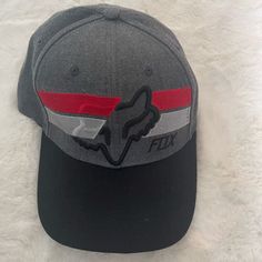 Racing Fox Men/Women Hat. Never Used. Color Red/Grey/Black. Gray Snapback Hat For Sports Events, Gray Curved Bill Hat For Streetwear, Gray Fitted Hat With Curved Brim, Gray Curved Brim Fitted Hat, Gray Visor Hat For Sports Events, Gray Curved Brim Hat For Sports Events, Gray Curved Bill Fitted Hat, Gray Hat One Size For Sports Events, Casual Gray Hat For Sports Events