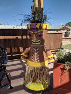 an inflatable tiki planter with grass growing out of it