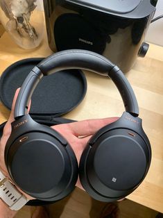 a pair of headphones sitting on top of a table next to a toaster