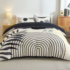 a bed with black and white designs on it