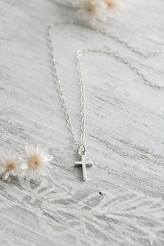 Display your faith with this handcrafted sterling silver dainty cross necklace. This beautiful simple necklace is lightweight and perfect for everyday wear. The cross is more than the universal symbol of Christianity. This simple design carries the message of love, finality, fulfilled promises, and more to people around the world. The perfect gift for baptism, first communion, confirmation and more. Make your necklace even more special with the addition of a birthstone or initial charm. ✥ Solid Delicate Sterling Silver Cross Pendant Necklace, Simple Everyday Cross Pendant Necklace, Silver Sterling Cross Necklace With Delicate Chain, Simple Everyday Cross Necklace, Minimalist Cross Pendant Necklace For Baptism, Minimalist Cross Pendant Necklaces For Baptism, Dainty Sterling Silver Cross Pendant Charm Necklace, Dainty Cross Necklace For Everyday, Simple Sterling Silver Cross Pendant Necklace