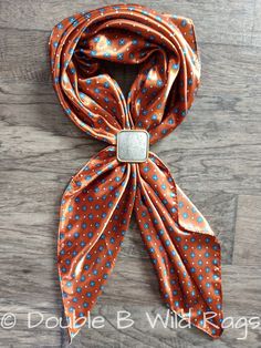 an orange and blue polka dot scarf on a wooden floor