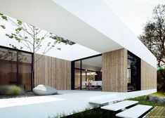 a modern house with wooden walls and white steps leading up to the front door area