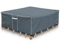 a table with two wooden legs and a cover over it that has been placed on top of the table