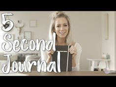 a woman sitting at a table holding up a box with the words 5 second journal