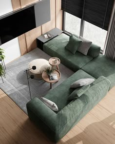 a living room with a large green couch and coffee table in the middle of it