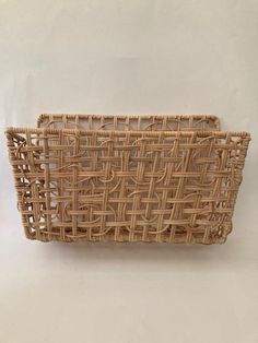 a woven basket sitting on top of a white table