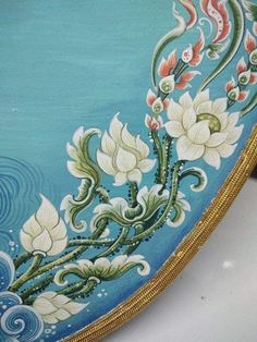 an ornately decorated blue plate with gold trimmings and floral designs on it