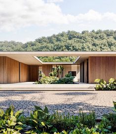 the house is surrounded by greenery and trees