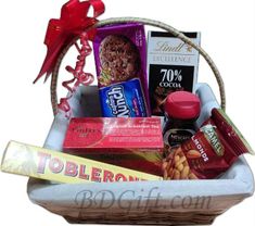 a basket filled with lots of different types of snacks and candys on top of a table