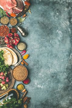 an assortment of food is laid out on a blue table top with space for text