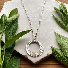 "This elegant necklace offers up a unique combination of playfulness & timeless style. Six organically shaped & uniquely textured sterling silver circles layer gracefully on a lovely sterling silver double cable chain. Each ring is handcrafted individually to represent your journey through the decades. Circles are hammered flat & strong, and given a rustic sparkly texture.  The circles shimmer & move gracefully with you, capturing the light & landing in various arrays. This piece is a beautiful Elegant Gift Wrapping, Through The Decades, Birthday Necklace, Birthday Milestone, Layered Rings, 60th Birthday Gifts, Elegant Necklace, Handcrafted Necklace, 80th Birthday