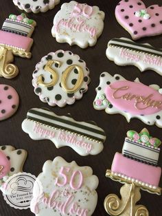 decorated cookies are arranged on a table for someone's 50th birthday