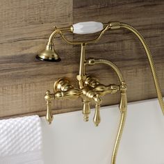 a gold faucet and shower head in a bathroom