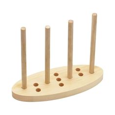 a wooden peg board with four holes in the middle and three smaller ones on each side