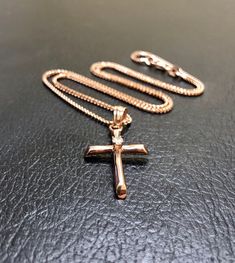 DeKara Designs Clearance Metal- 14K Rose Gold, .583. Stone- 1 Round Diamond F-G Color VS1-VS2 Clarity, 0.07 Carats. Modern Minimalist Handmade 14K Rose Gold Diamond Cross Necklace/Pendant. The center of the cross has a professionally prong set round fiery diamond. The cross is 1.20 inches long including the bail and 0.62 inches wide. The cross has a beautiful shine with a high polished finish. Necklace is a beautiful diamond cut wheat chain made in 14K Rose Gold and is 16 inches in length. FREE Rose Gold Cross Pendant Necklace In Fine Jewelry Style, Rose Gold Cross Pendant Necklace, Fine Jewelry Rose Gold Cross Pendant, Rose Gold Cross Pendant Fine Jewelry, 14k Rose Gold Cross Pendant Jewelry, 14k Gold Rose Gold Cross Jewelry, Rose Gold Cross Jewelry In 14k Gold, Rose Gold Cross Necklace In Fine Jewelry Style, 14k Rose Gold Cross Jewelry