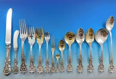 an assortment of silverware including forks, knives and spoons on a blue background