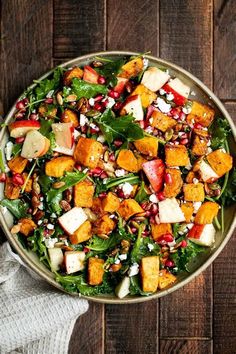 a salad in a bowl on top of a wooden table