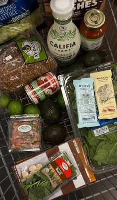 the grocery cart is full of food and condiments, including avocado