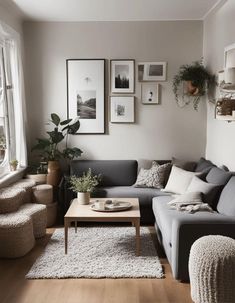 a living room filled with lots of furniture and pictures on the wall above it's windows