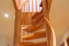 a wooden spiral staircase in a home