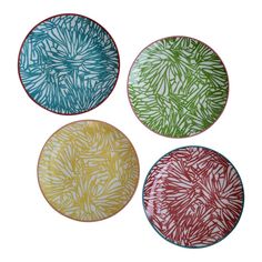 four plates with different designs on them