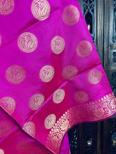 Gorgeous Magenta Pink Banarasi Dupatta. Dupatta is Soft and will add beauty to any Outfit. Makes a Perfect Gift! PLEASE NOTE - TASSLES AT THE ENDS OF THE DUPATTA ARE BLACK IN COLOR. Item: DupattaColor : Magenta Pink with Muted Gold Zari Weaving Fabric : Banarasi Silk (Non Pure Silk)Work : Zari Weaved with tassels Length of the dupatta : 35 inches (approx)Width of the dupatta : 92 inches (approx)Store Policies- No return or exchange will be accepted for color variations.- No return or exchange wi Eid Celebration Shawl With Pallu, Banarasi Silk Blouse Piece With Latkans For Eid, Festival Banarasi Silk Saree With Latkans, Diwali Banarasi Silk Saree With Latkans, Festival Jamawar Blouse Piece, Festival Traditional Wear In Banarasi Silk With Latkans, Banarasi Silk Blouse Piece With Latkans, Banarasi Silk Bollywood Blouse Piece With Latkans, Traditional Banarasi Silk Blouse With Latkans