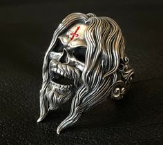 Glen Benton Death Skull Ring Limited to 33 Pieces The ring that embodies the legend himself. It truly is a collector's item for the die-hard fans. Due to limited worldwide exclusivity, custom ring size will be offered only after each confirmed order. Renowned for the inverted cross he has repeatedly branded into his forehead over the years, Glen Benton was notorious for his statement that he would commit Sacrificial Suicide at the age of 33, supposedly the same age Jesus Christ died. Glen's pers Glen Benton, Grand Theft Auto Series, Punk Glam, Inverted Cross, Leather Jacket Men Style, Wallet Chains, Bold Statement Jewelry, Exotic Jewelry, Metal Skull