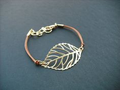 a bracelet with a leaf charm on it