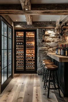 a wine cellar with wooden floors and stone walls