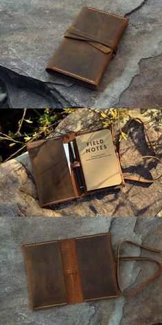 two brown leather notebooks sitting on top of a rock next to a book bag