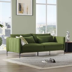 a living room with a green couch and white rug in front of two large windows