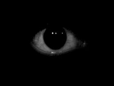 an eye is shown in the dark