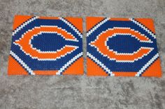 two chicago bears coasters made out of plastic beads and bead work on carpet