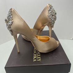 100% Authentic Available In Two Sizes : 6.5 And 7.5 Please Choose The Size You Want During Checkout Comes With Original Box And Dust Bags Brand New Badgley Mischka Gold Champagne Satin Peep Toe Pumps These Are The Perfect Shoe For Brides , Parties , Balls, Weddings , Or Any Formal Event Embellished With A Large Cluster Of Crystals On Back Of Shoe . Smooth Champagne Nude Color Satin . Peep Toe With A Hidden 1/2” Platform . 4.5” Slim Heel These Are Gorgeous ! Elegant Embellished Wedding Shoes For Cocktail, Elegant Bedazzled Heels For Events, Elegant Bedazzled Heels For Gala, Elegant Bedazzled Wedding Shoes For Party, Evening Wedding Shoes Embellished Almond Toe, Embellished Open Toe Wedding Shoes For Gala, Bedazzled Heels For Gala, Embellished Almond Toe Wedding Shoes For Evening, Elegant Embellished Champagne Wedding Shoes