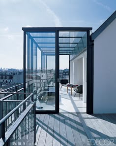 a balcony with glass walls overlooking the city